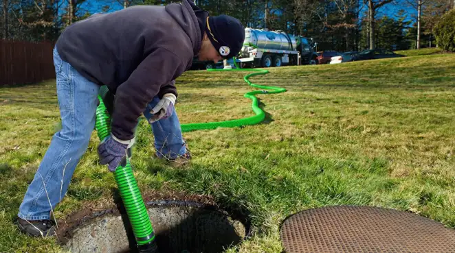 Service technician performing residential septic pumping and drainage maintenance in Stockton, CA